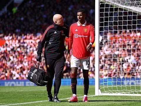 Manchester United's Marcus Rashford is helped off the pitch after sustaining an injury.