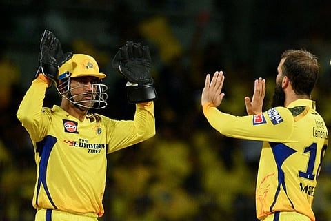 Chennai Super Kings' Moeen Ali (right) celebrates with his captain Mahendra Singh Dhoni after taking the wicket of Lucknow Super Giants' Krunal Pandya (not pictured) during the Indian Premier League match at the MA Chidambaram Stadium in Chennai.