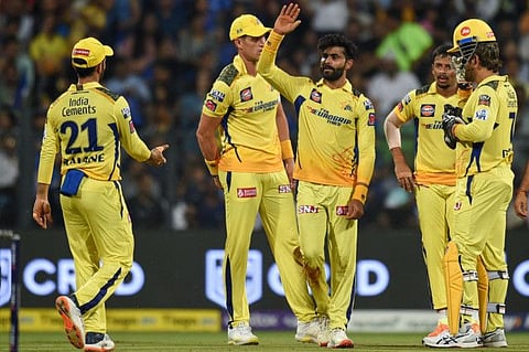 Chennai Super Kings' Ravindra Jadeja (centre) celebrates with teammates after taking the wicket of Mumbai Indians' Tilak Varma (not pictured) during the Indian Premier League at the Wankhede Stadium in Mumbai.