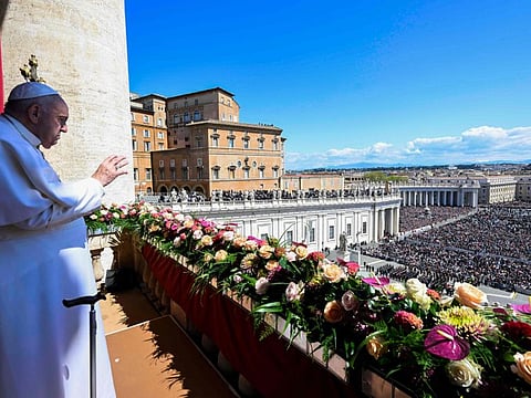 This photo taken and issued as a handout on April 9, 2023 by the Vatican Media shows Pope Francis wave after he delivered the Urbi et Orbi message and blessing for Easter from the loggia of St. Peter's basilica overlooking St. Peter's square in The Vatican.