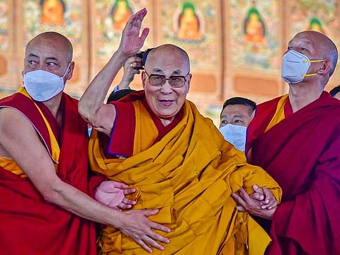 In this file photo taken on December 29, 2022, Tibetan spiritual leader Dalai Lama waves during his first day of teaching session at the Kalachakra Ground in Bodhgaya.
