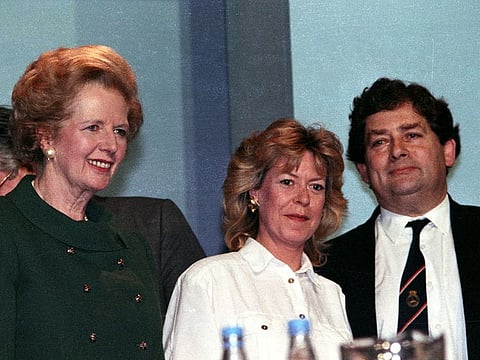 File: The then-British Prime Minister Margaret Thatcher (left) smiles as Chancellor of Exchequer Nigel Lawson (right) receives standing ovation after his reply on the debate on the economy at Conservative Party Conference on October 12, 1989.