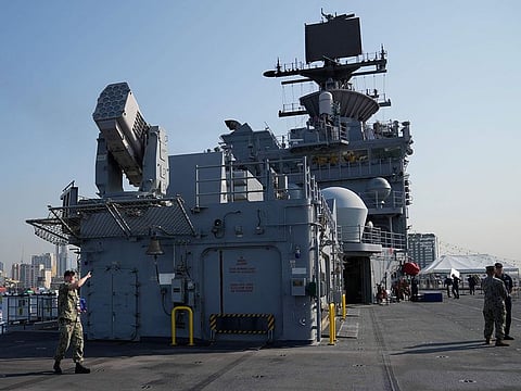 A U.S. Marines personnel gestures at the flight deck of the USS America (LHA 6) during a scheduled port visit in Manila, Philippines.