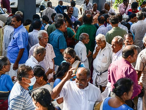 Pensioners chat as hundreds of them gather for a meeting in Piravom, Kerala state, India, March 31, 2023.