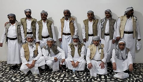 This handout picture obtained from the Twitter account of Abdul Qader Al Mortada, head of the Houthi National Committee for Prisoners Affairs (NCPA), on April 8, 2023 shows 13 prisoners released by the Saudi authorities in exchange for a Saudi prisoner freed earlier, upon their arrival at Sana'a International airport in the Yemeni capital.