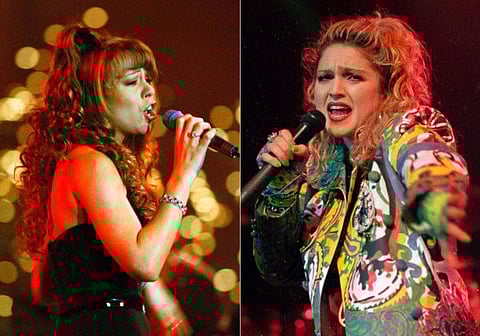 Mariah Carey performs a benefit for the Fresh Air Fund at the Cathedral of St. John the Divine in New York on Dec. 8, 1994, left, and Madonna performs as she opened her Virgin tour in Seattle, on April 10, 1985. An album from Madonna, a carol from Mariah Carey and music from “Super Mario Bros.” are among the audio titles the US. National Recording Registry. The Library of Congress announced Wednesday, April 12, 2023, that 25 recordings have been selected for preservation for their cultural significance.  (AP Photo)