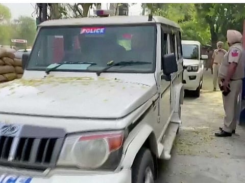 Police vehicles leave a police station, following a "firing incident" at a military station that killed four people, in Bhatinda, Punjab, India, April 12, 2023 in this screengrab taken from a handout video.