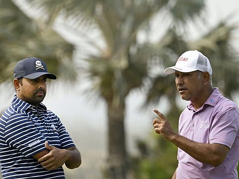 Dubai residents Jeev Milkha Singh (right) and Anirban Lahiri chat on the practice green during day one of the International Series - Vietnam