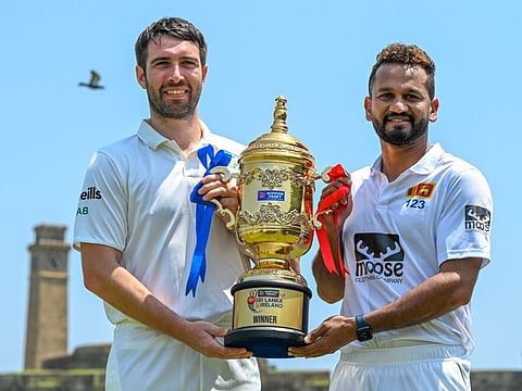 Sri Lanka's captain Dimuth Karunaratne (right) and Ireland's captain Andrew Balbirnie pose with the Test trophy on the eve of their first cricket Test match at the Galle International Cricket Stadium in Galle.