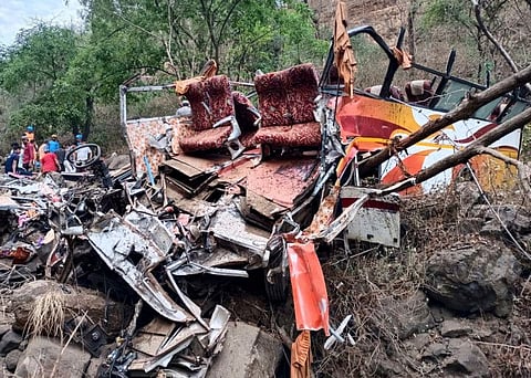 Police and rescue officials inspect the wreckage of a passenger bus near Khopoli, some 70 kilometres (43 miles) from Mumbai, on April 15, 2023.