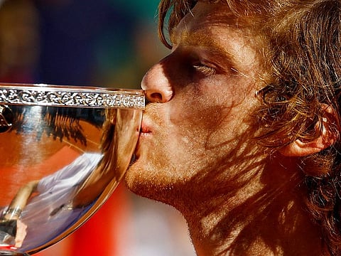 Russia's Andrey Rublev kisses the trophy after winning the final against Denmark's Holger Rune.