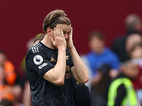 Arsenal's Rob Holding looks dejected after the match.