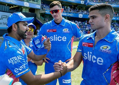 Mumbai Indians Rohit Sharma (left) hands over the debut IPL cap to Arjun Tendulkar (right) during the match against Kolkata Knight Riders at Wankhede Stadium, in Mumbai.