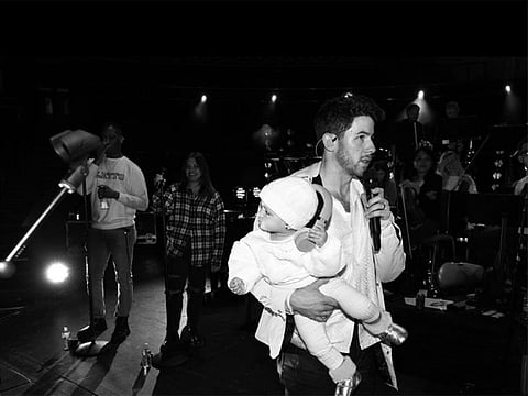 Nick Jonas does sound check before his concert with daughter Malti in tow