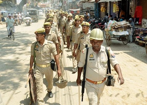 Police personnel conduct a flag march to maintain law and order in sensitive areas following the killing of gangster turned politician Atiq Ahmed and his brother Ashraf by three assailants in Prayagraj, in Mirzapur on Sunday, April 16, 2023.