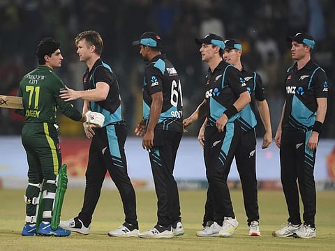 Pakistan's Naseem Shah (left) shakes hands with New Zealand's players at the end of the third Twenty20 international at the Gaddafi Cricket Stadium in Lahore.