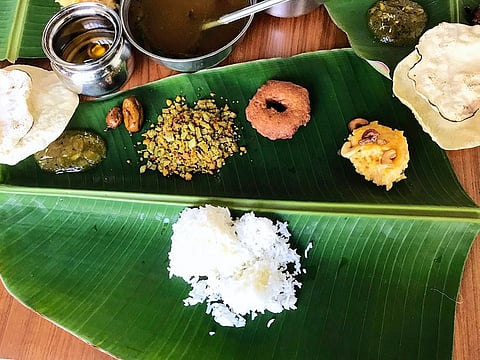A complete Puthandu feast served on fresh banana leaf