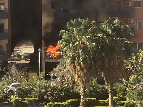 Smoke and fire rise from an apartment building in a residential complex, after a shell hit the building according to eyewitness, in Khartoum, Sudan April 19, 2023, in this still image obtained from a social media video.