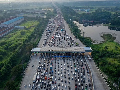 An aerial photo of a traffic jam at a toll booth of a highway, as Indonesian Muslims go back to their hometown to celebrate Eid Al Fitr.