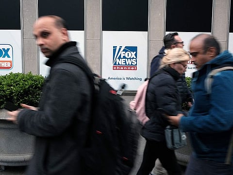 People walk by the News Corporation headquarters, home to Fox News, on April 18, 2023 in New York City.