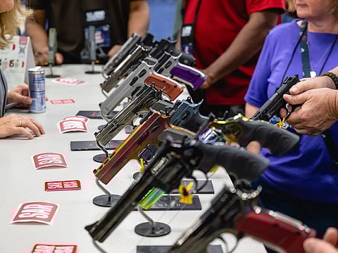 Attendees view handguns at the SAR booth during the National Rifle Association (NRA) annual convention in Indianapolis, Indiana, US