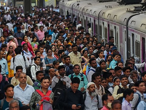 People crowd on platforms as they wait for their train at the Chhatrapati Shivaji Terminus (CST) railway station Mumbai on April 19, 2023.