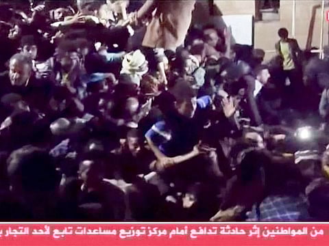 People trapped in the crowd attempt to free themselves during a stampede in Sanaa, Yemen, April 19, 2023, in this still image taken from video.