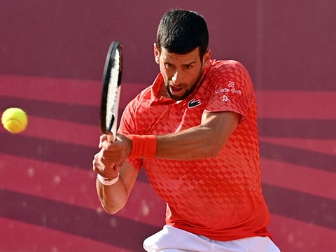 Serbia's Novak Djokovic plays a backhand return to compatriot Dusan Lajovic during their singles quarterfinals on Friday.
