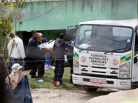 A body is moved at the scene of a deadly mass shooting near Pietermaritzburg, South Africa on April 21, 2023.