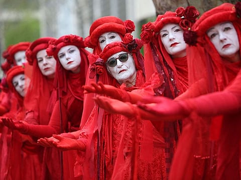 Members of performance troupe Red Rebel Brigade march in central London
