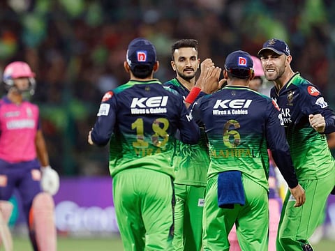 Royal Challengers Bangalore's Harshal Patel celebrates a wicket with teammates against Rajasthan Royals in Bengaluru on Sunday.