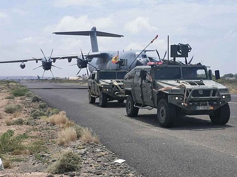 Spanish military plane and military vehicles are seen departing on tarmac as Spanish diplomatic personnel and citizens are evacuated, in Khartoum, Sudan, April 23, 2023.