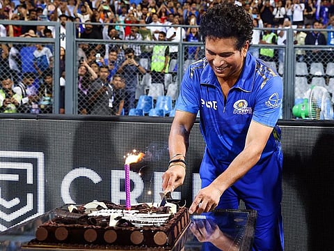Sachin Tendulkar cuts a cake ahead of his 50th birthday during the clash between Mumbai Indians and Punjab Kings at Wankhede Stadium in Mumbai on Saturday.
