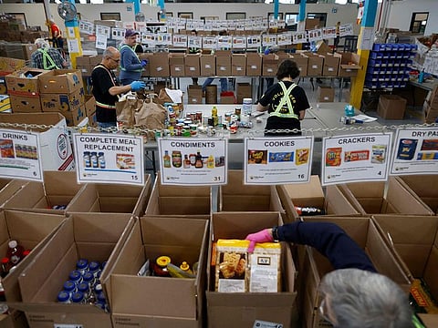 Volunteers sort through donated groceries at Daily Bread Food Bank in Toronto, Ontario, Canada.