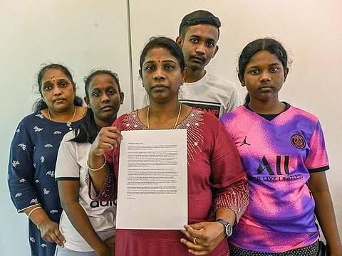 Leelavathy Suppiah (C), sister of a convicted drug trafficker Tangaraju Suppiah, who is scheduled for execution, poses with family members as she holds a petition letter to seek clemency in Singapore.