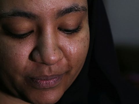 Rawan Al Waleed, a Sudanese woman who has fled Khartoum, cries during an interview with Reuters as she stays at her aunt's house in Cairo, April 24, 2023.