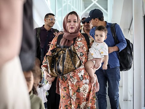 Moroccan citizens evacuated from Sudan arrive at the Casablanca Mohammed V Airport on April 26, 2023.
