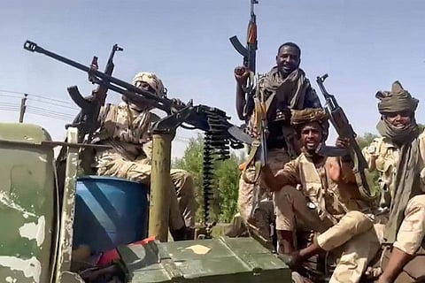 In this image grab taken from handout video footage released by the Sudanese paramilitary Rapid Support Forces (RSF) on April 23, fighters ride in the back of a technical vehicle (pickup truck mounted with a turret) in the East Nile district of greater Khartoum.