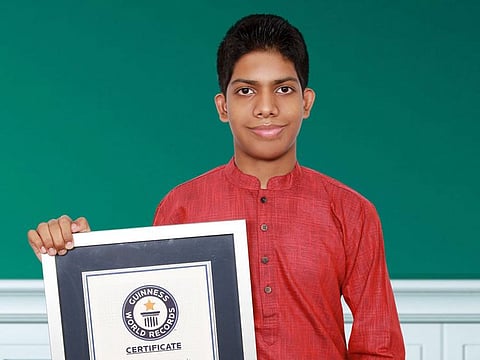 Amit Ramkumar with the 'Guinness World Record for the largest magnet number' certificate.