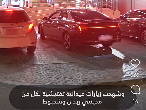 Still from municipality video showing cars parked on the sidewalk in Abu Dhabi