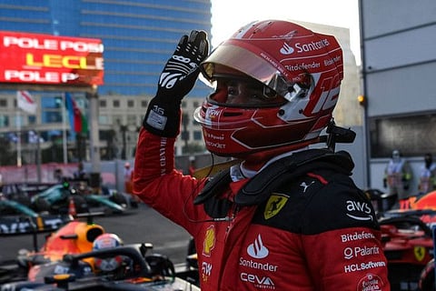 Ferrari's Monegasque driver Charles Leclerc reacts after taking the pole position after the qualifying session.