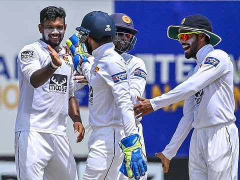 Sri Lanka's Ramesh Mendis (left) celebrates with teammates after taking the wicket of Ireland's Andrew Balbirnie during the fifth day of the final Test in Galle on Friday.