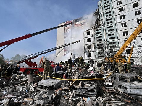 Rescuers work in the rubble of a damaged residential building in Uman, south of Kyiv on April 28, 2023, after Russian missile strikes targeted several Ukrainian cities overnight.