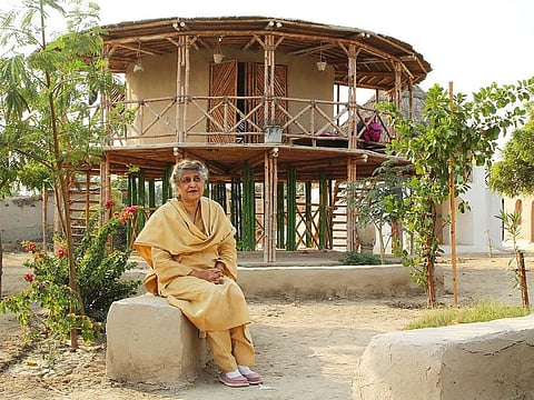 Yasmeen Lari outside Women’s Centre in Sindh. The shelter is made from bamboo, mud, and lime.