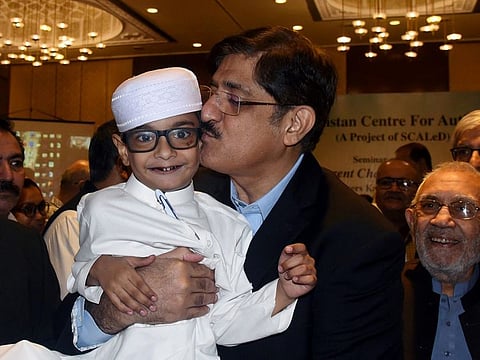 Sindh Chief Minister Syed Murad Ali Shah with one of the autistic children who participated in seminar organised by Pakistan Centre for Autism.