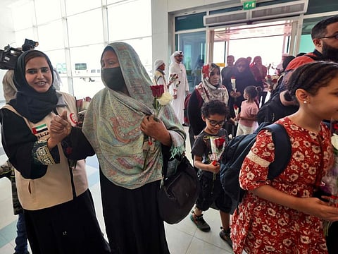 People fleeing conflict in Sudan are welcomed by Emirati officials after an evacuation flight landed in Abu Dhabi on April 29, 2023.