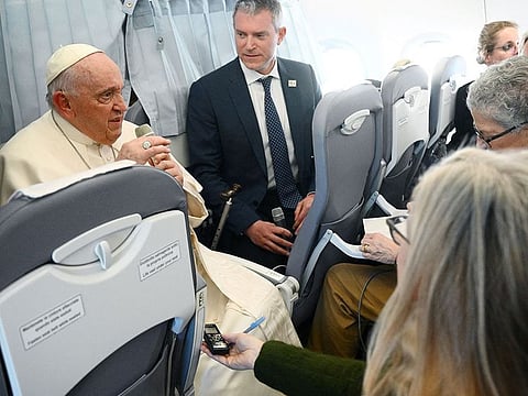 Pope Francis holds a news conference aboard the plane as he returns to the Vatican.