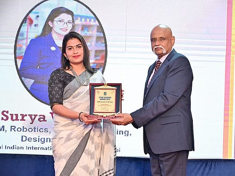 Surya Vignesh (left), from Global Indian International School in Abu Dhabi, shared the coveted STEM Teacher of the Year Award, presented by the Director of BPDC Professor Srinivasan Madapusi.