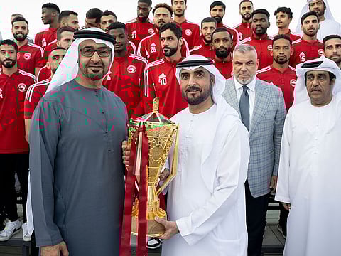 Sheikh Mohammed Bin Zayed Al Nahyan with members of the Al Sharjah Football Club for winning the President's Cup at Sea Palace Barza.