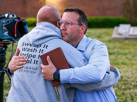 Pastor Ryan Wells hugs Nathan Brewer, the father of Brittany Brewer who was found dead, after a vigil in Henryetta, Okla., on Monday, May 1, 2023.